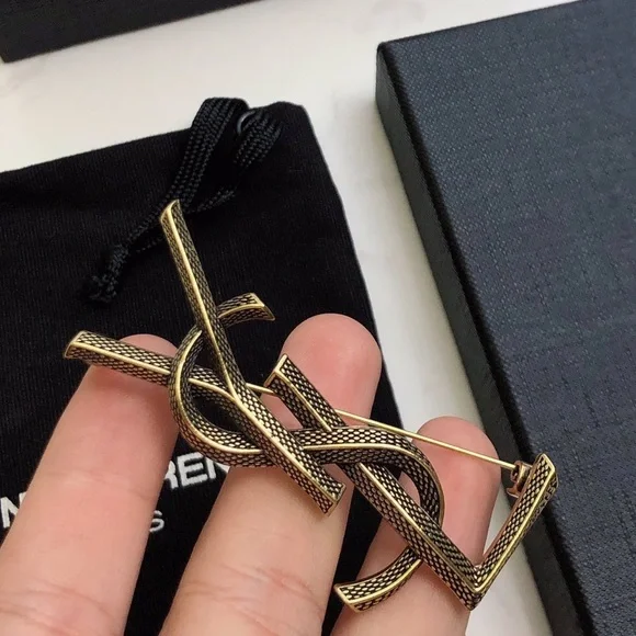 Saint Laurent Black and Gold Intertwined Brooch - Picture 1 of 4